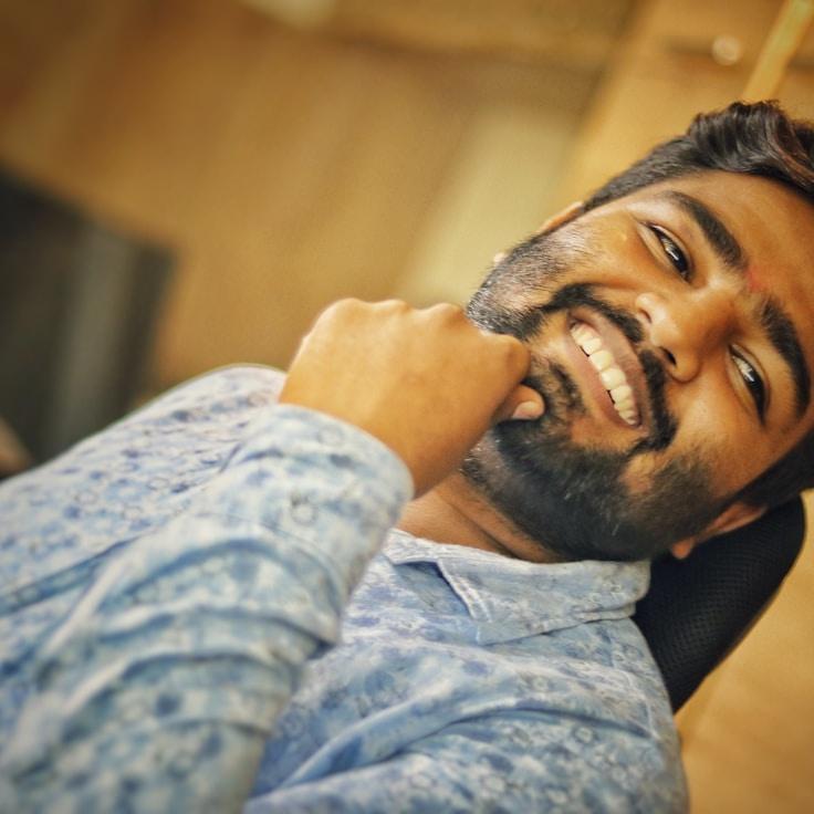 Avery Singh, Lead Design Curator at Harvest Bridge, reviewing corporate floral arrangements